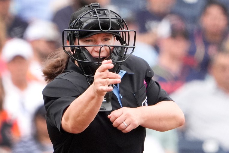 Home plate umpire Jen Pawol calls a strike