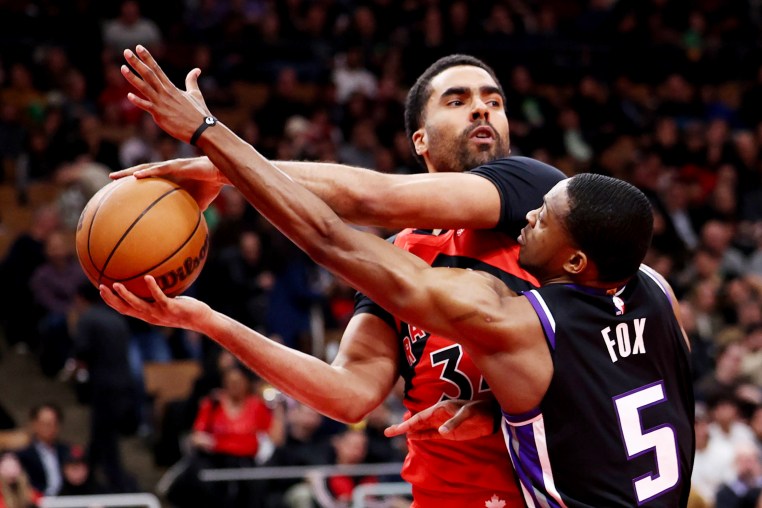 Jontay Porter of the Toronto Raptors battles De'Aaron Fox) of the Sacramento Kings on
March 20, 2024.