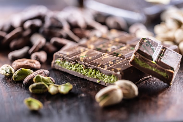 Dubai Chocolate bar with green kadayif and pistachio spread with pistachio nuts - close up