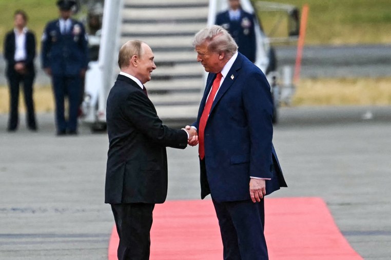 Image: President Donald Trump greets Russian President Vladimir Putin