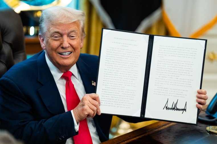 Donald Trump holds up a signed letter