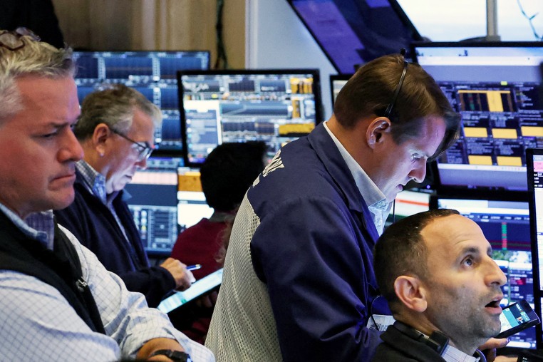 Traders work on the floor of the NYSE in New York