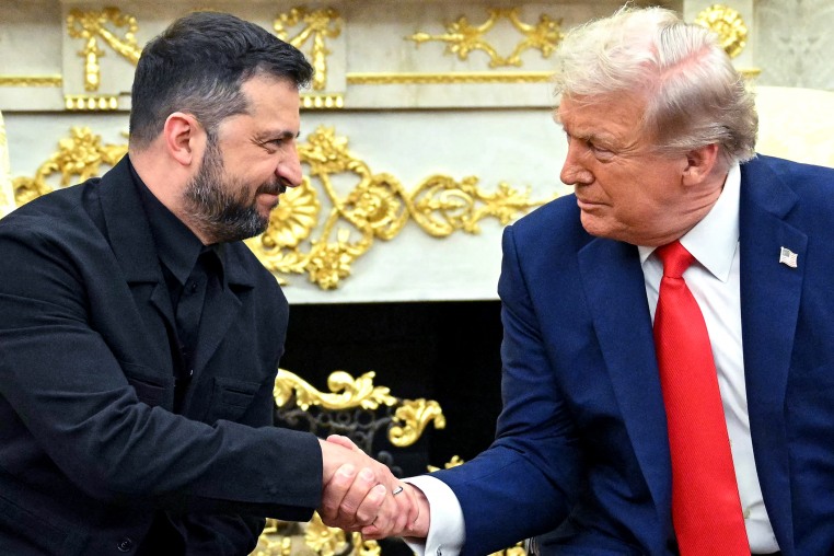 Volodymyr Zelenskyy, left, and Donald Trump shake hands