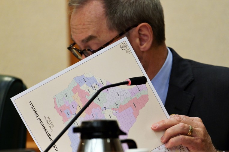 Kevin Sparks looks at a copy of the proposed 2025-2026 redistricting map 