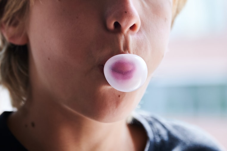 A child chews gum.