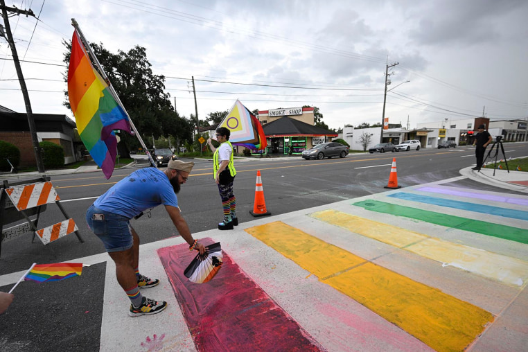 Activists rally at the Pulse Interim Memorial after repainting a rainbow-colored crosswalk on Friday, Aug. 22, 2025, in Orlando, Fla. 