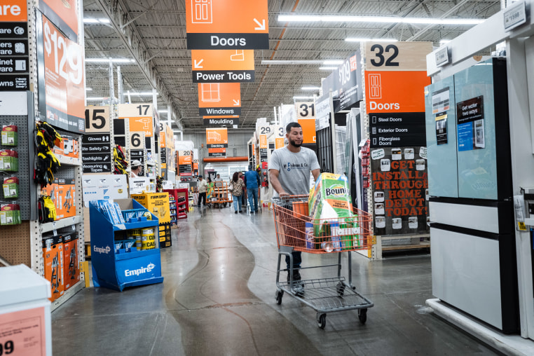 A shopper pushes a cart in a Home Depot store