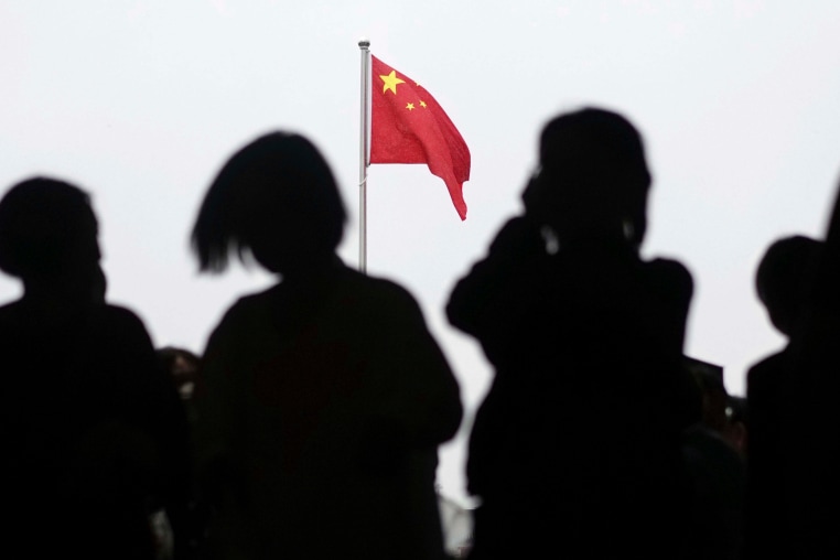 A Chinese flag is raised in Tiananmen Square 