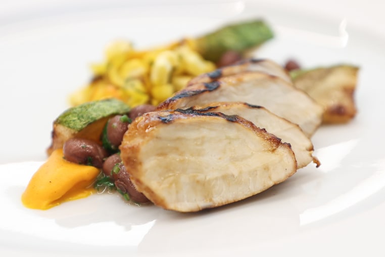 Chicken, beans, and other ingredients on a plate