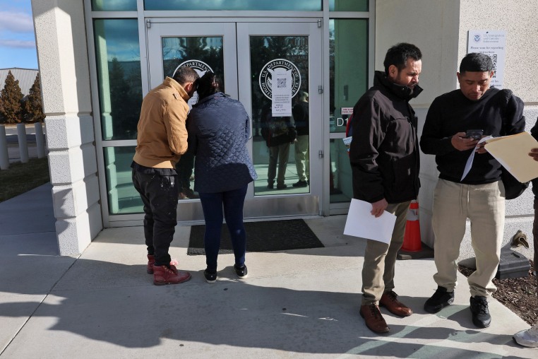 People arrive for appointments at U.S. Immigration and Customs Enforcement (ICE) in Chantilly, Virginia.