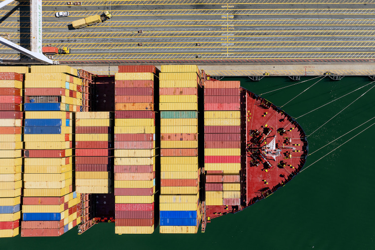Cargo containers line a ship 