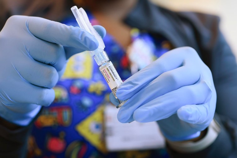 A nurse holds a COVID-19 vaccine in Miami.