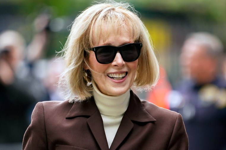 E. Jean Carroll smiles as she arrives at Manhattan federal court