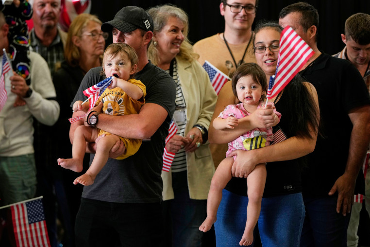 Afrikaner refugees holding US flags.