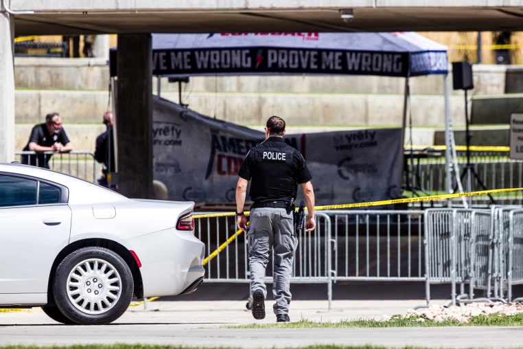 A police officer walks toward the crime scene tent