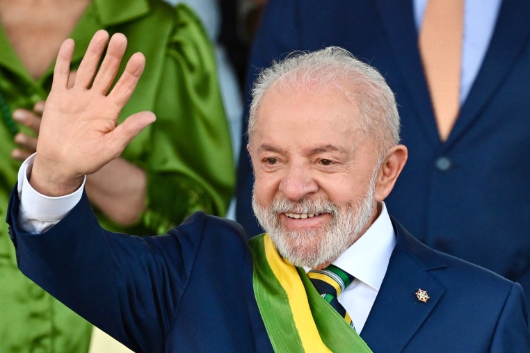 Luiz Inacio Lula da Silva smiles as he waves
