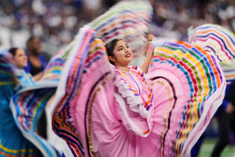 Dancers perform at an NFL halftime for Hispanic Heritage Month Sunday, Sept. 14, 2025, in Arlington, Texas. 
