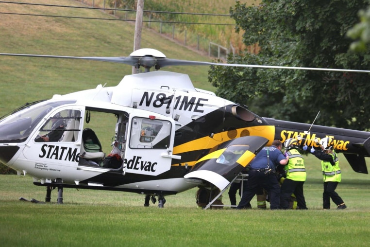 An officer is loaded into a helicopter
