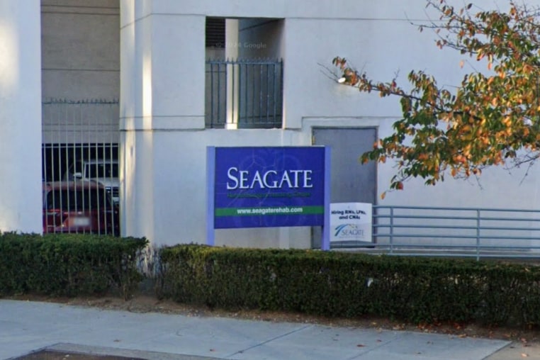 The exterior blue sign for Seagate Nursing and Rehabilitation Center
