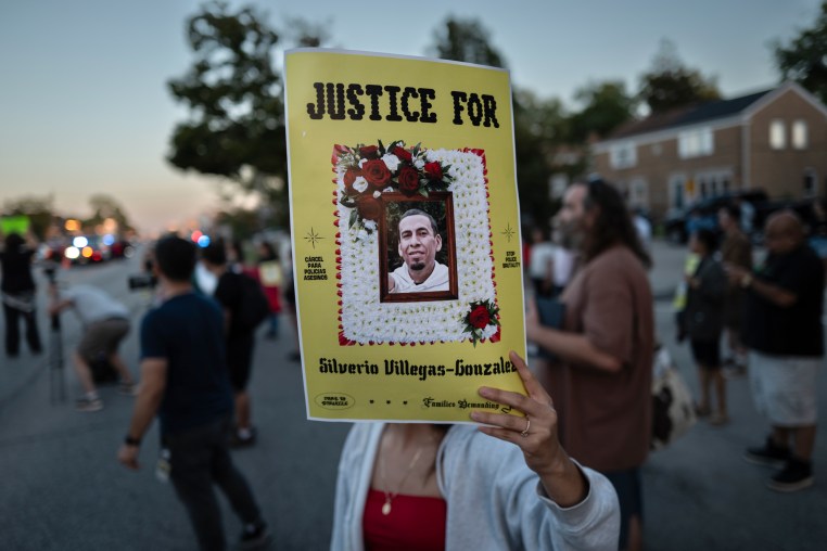 A person holds a sign in memory of Silverio Villegas Gonzalez