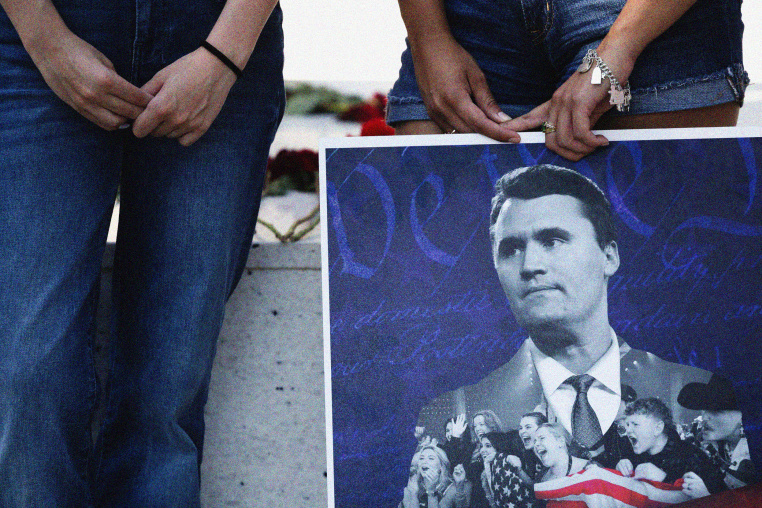Jordyn Hackner, president of Turning Point USA's University of Houston chapter, and Lizbeth Aguilar, stand with a poster of Charlie Kirk at a vigil on the university campus in Houston, Texas, on Sept. 11, 2025.  