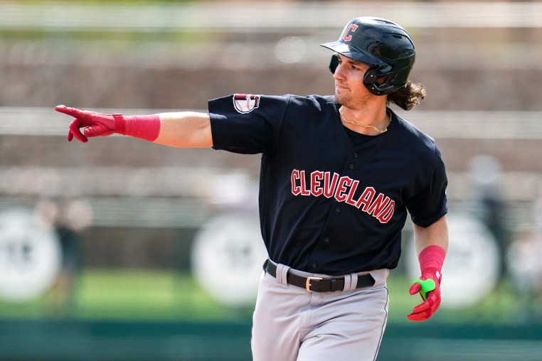 Chase DeLauter points while running on the baseball field