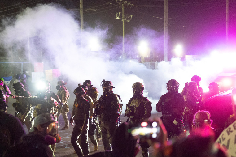 Federal law enforcement agents use tear gas and pepper balls during a protest outside an immigrant processing center on Sept. 27, 2025 in Broadview, Ill.