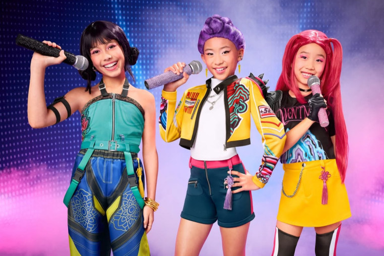 Three girls dressed up in Halloween costumes depicting characters from the girl group in KPop Demon Hunters