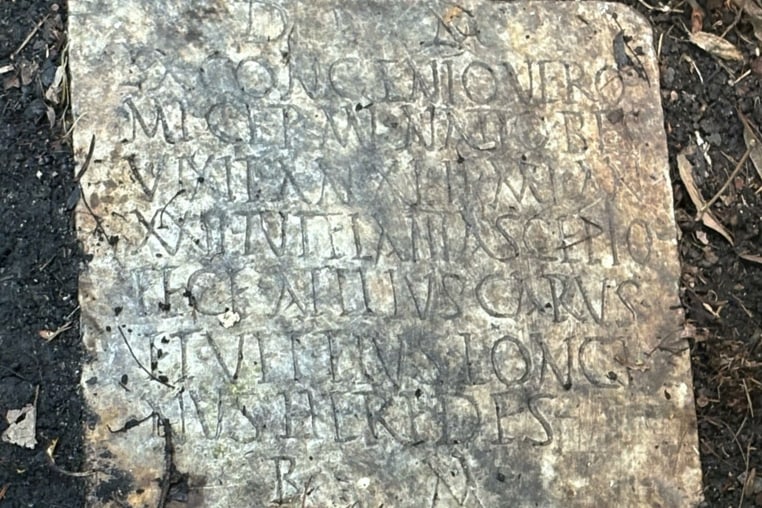 This photo provided by Tulane University classical archeologist Susann Lusnia shows a Latin inscription on the 1,900-year-old grave marker of a Roman sailor named Sextus Congenius Verus, discovered in a New Orleans backyard.