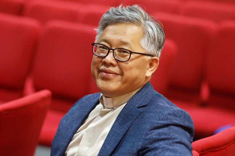 The head pastor of the Zion church in Beijing Jin Mingri poses for picures in the congregation hall of the unofficial Protestant "house" church in Beijing