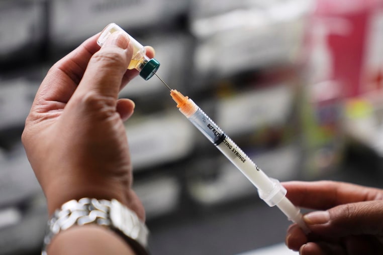 A medical assistant prepares a dose of the measles, mumps and rubella (MMR) vaccine.