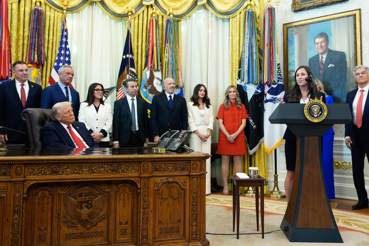 President Donald Trump listens as Sen. Katie Britt, R-Ala., speaks in the Oval Office of the White House.