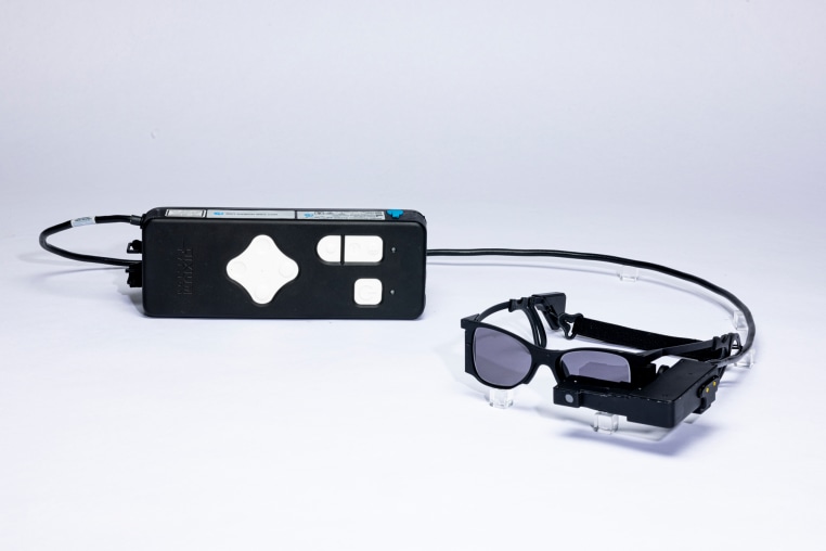 Glasses connected to a remote, laid on a white surface
