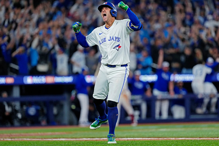 George Springer of the Toronto Blue Jays celebrates after hitting a three-run home run against the Seattle Mariners in the seventh inning on Oct. 20, 2025.