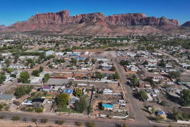 An aerial view of mountain tops and homes