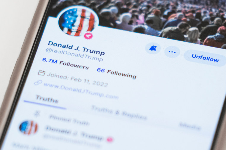 The Truth Social account for Donald Trump is seen on a mobile device.