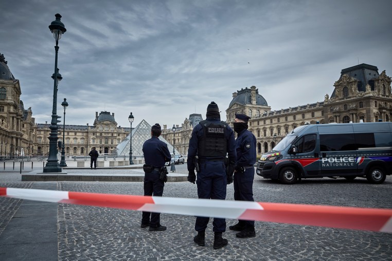 French Police officers seal off the entrance to the Louvre Museum after a Jewllery Heist.