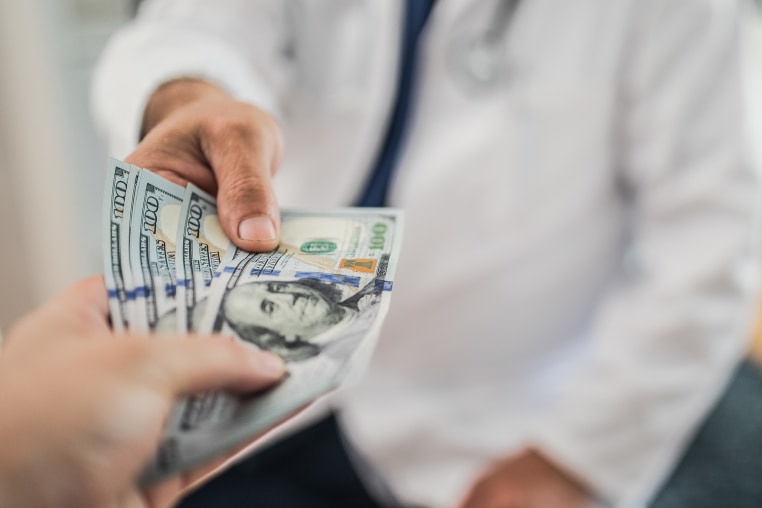 Paying medical bills with cash.