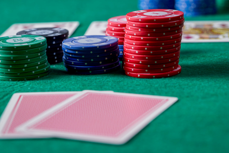 Close-up of a person showing a pair of jacks while playing poker. Poker game concept.
