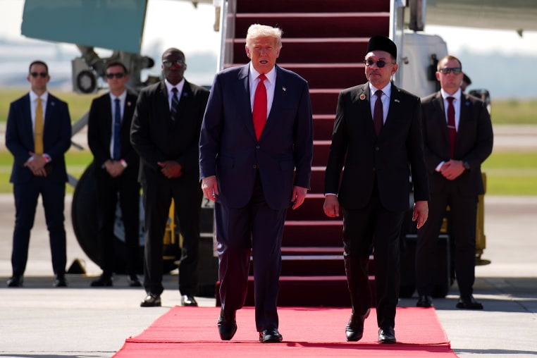 U.S. President Donald Trump is greeted by Malaysian Prime Minister Anwar Ibrahim as he arrives at Kuala Lumpur International Airport on October 26, 2025 in Kuala Lumpur, Malaysia.