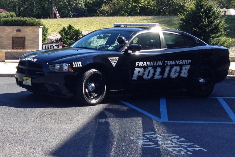 A Franklin Township Police vehicle is parked outside near a field.