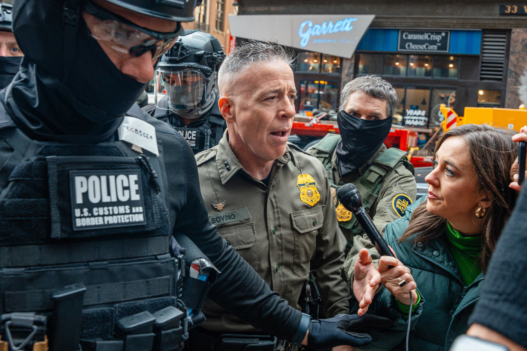 U.S. Border Patrol commander Gregory Bovino pushes through a crowd of media and protesters as he enters the Dirksen Federal Building on Oct. 28, 2025, in Chicago.