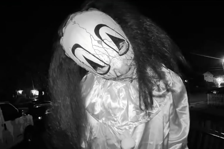 Individual in a clown mask caught  on Ring video.