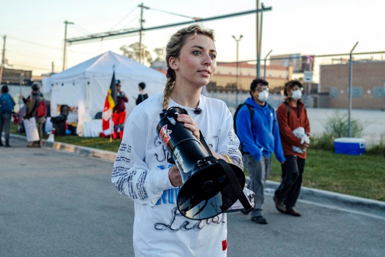 Kat Abughazaleh holds a megaphone outside of the Broadview ICE processing facility.