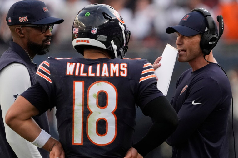 Sep 21, 2025; Chicago, Illinois, USA; Chicago Bears head coach Ben Johnson talks with quarterback Caleb Williams (18) against the Dallas Cowboys during the second half at Soldier Field. Mandatory Credit: David Banks-Imagn Images