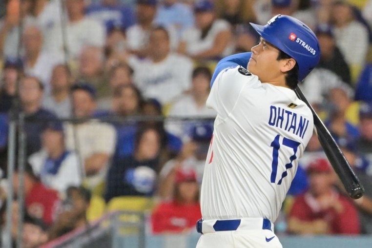 Sep 30, 2025; Los Angeles, California, USA; Los Angeles Dodgers designated hitter Shohei Ohtani (17) hits a two run home run during the sixth inning against the Cincinnati Reds during game one of the Wildcard round for the 2025 MLB playoffs at Dodger Stadium. Mandatory Credit: Jayne Kamin-Oncea-Imagn Images