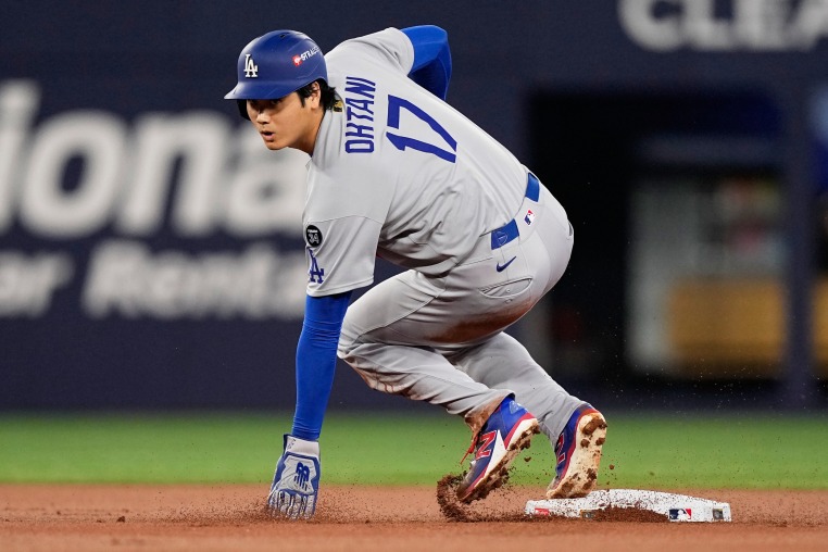 Los Angeles Dodgers' Shohei Ohtani is safe at second on a ball hit by Will Smith against the Toronto Blue Jays during Game 7 of the World Series.