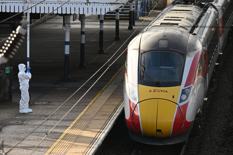 Forensic police officers examine the LNER train as it sits in Huntingdon Station after a stabbing attack on Nov 2.