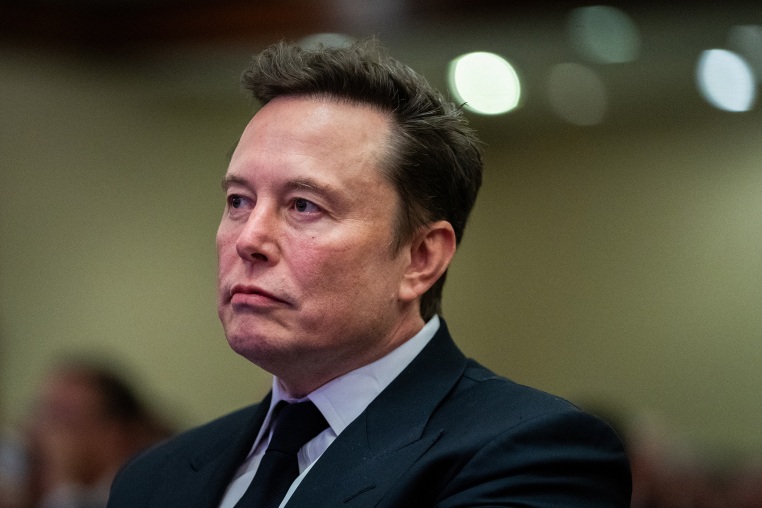 Elon Musk listens as President Donald Trump speaks during a meeting with House Republicans at the Hyatt Regency hotel in Washington, D.C. on November 13, 2024.