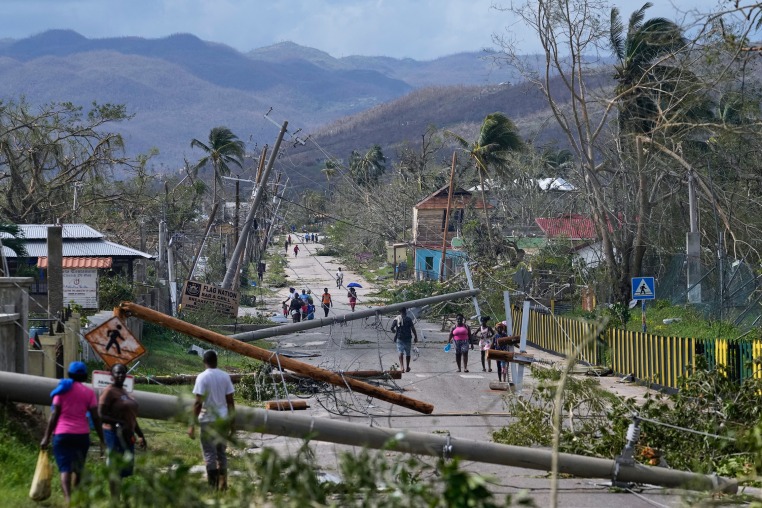 Residents walk through the aftermath of Hurricane Melissa in Jamaica.